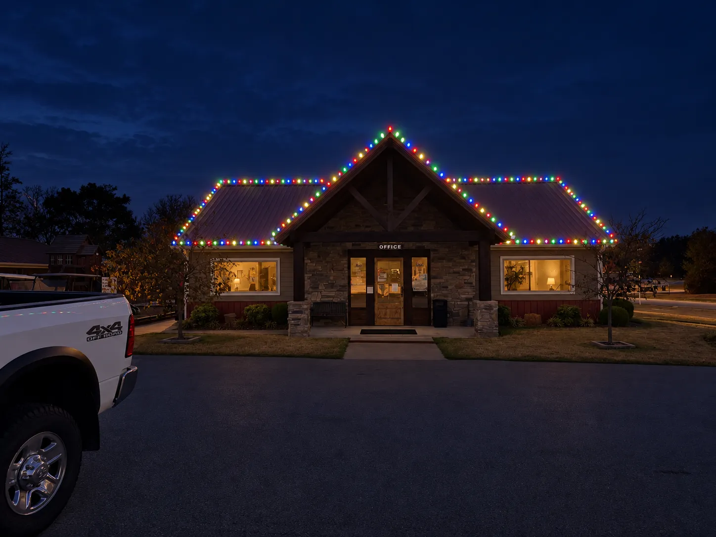 Commercial office building outlined in bright multicolor C9 Christmas lights